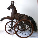 antique child's wood carved tricycle for display