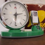 vintage midcentury wind up enamel alarm cock with flip calendar