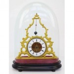 antique french skeleton clock under dome