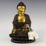 antique bronze buddha on carved wood lotus base