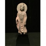 ancient buddha stone statue on stand